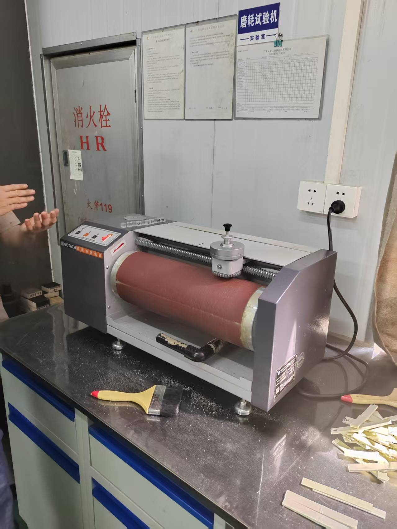 Abrasion testing machine on a laboratory bench