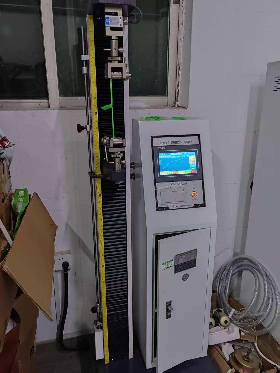 Tensile testing machine with a green test specimen