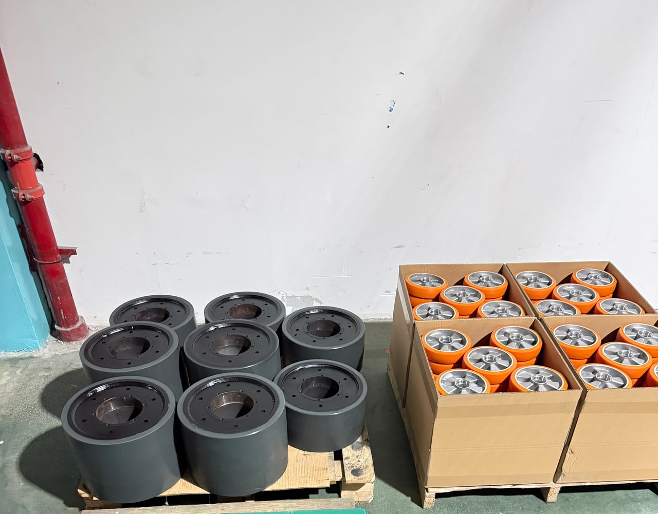 Packed orange wheels and pallet of dark wheels